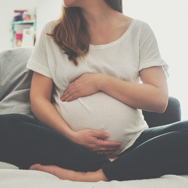 Pregnant woman touching her belly